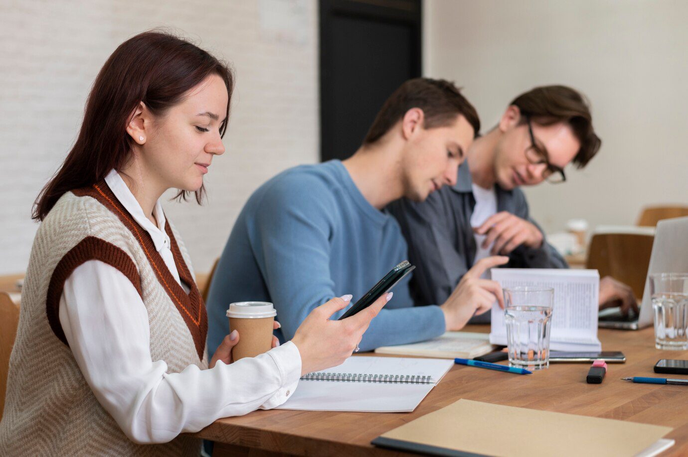 A group of people sitting at a table with papers.