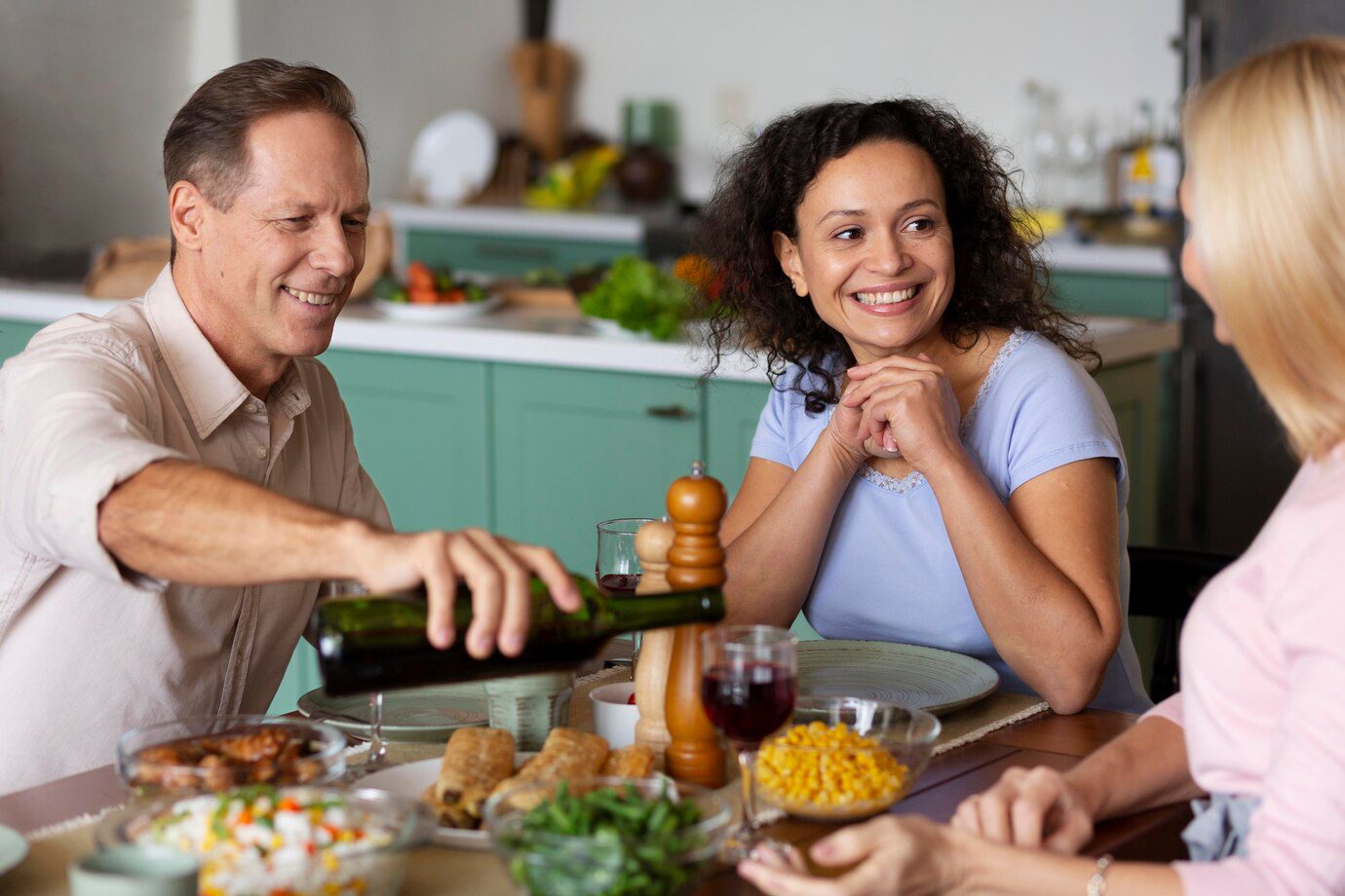 A group of people sitting around a table with food.