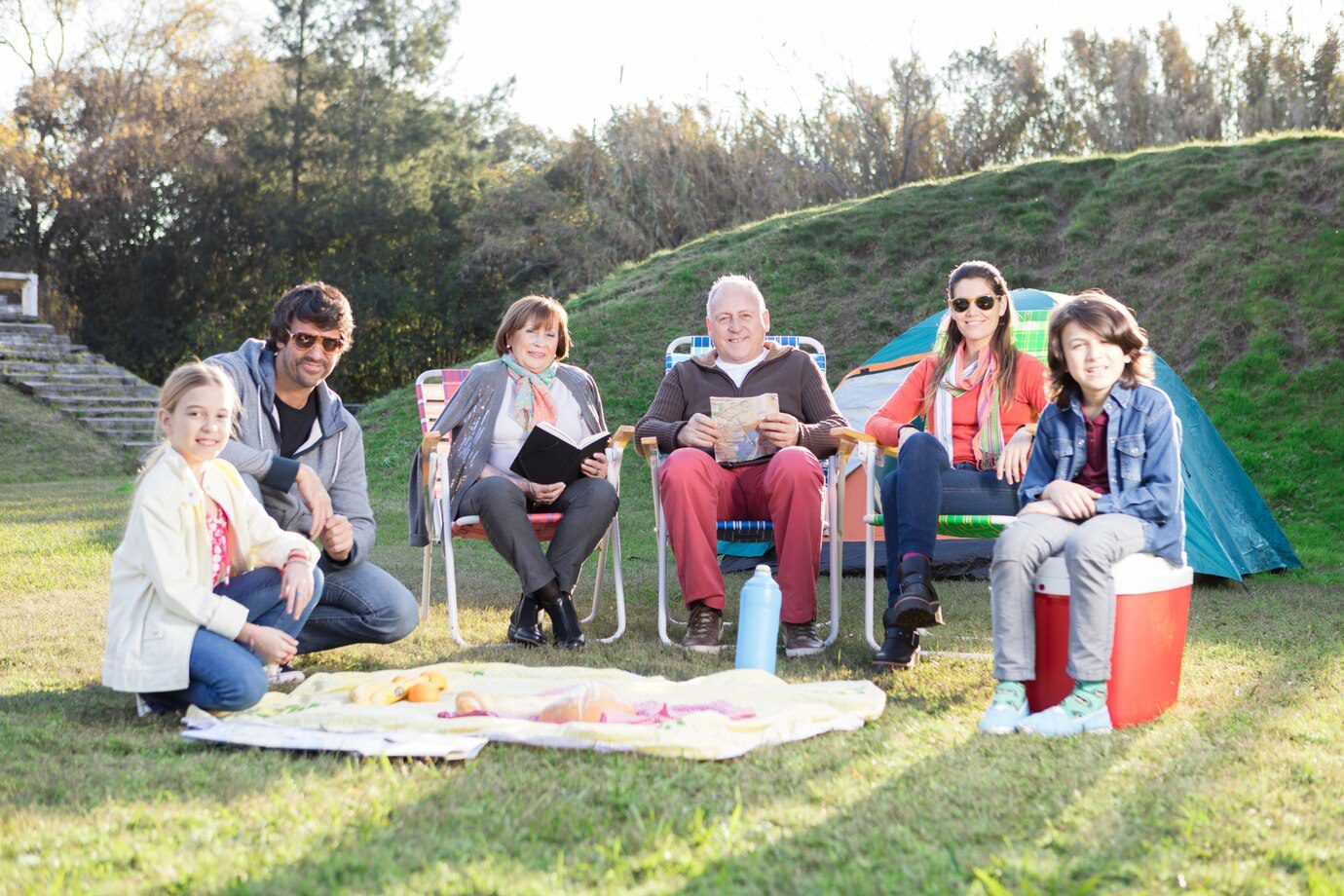 A group of people sitting on lawn chairs.