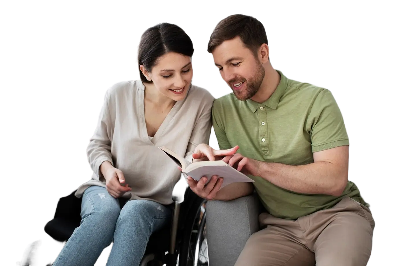 A man and woman sitting in front of a book.