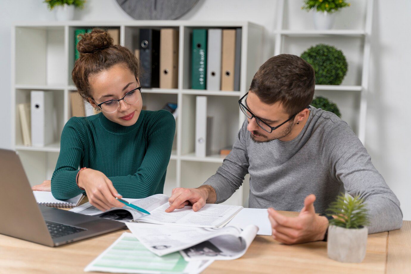 A man and woman are looking at papers.