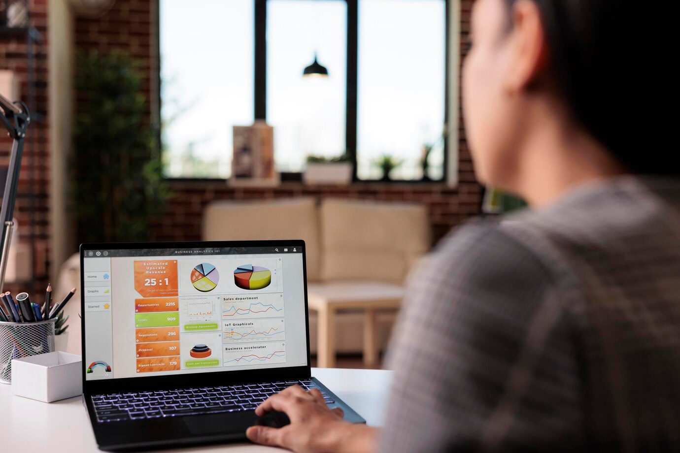 A man sitting at a table using his laptop.