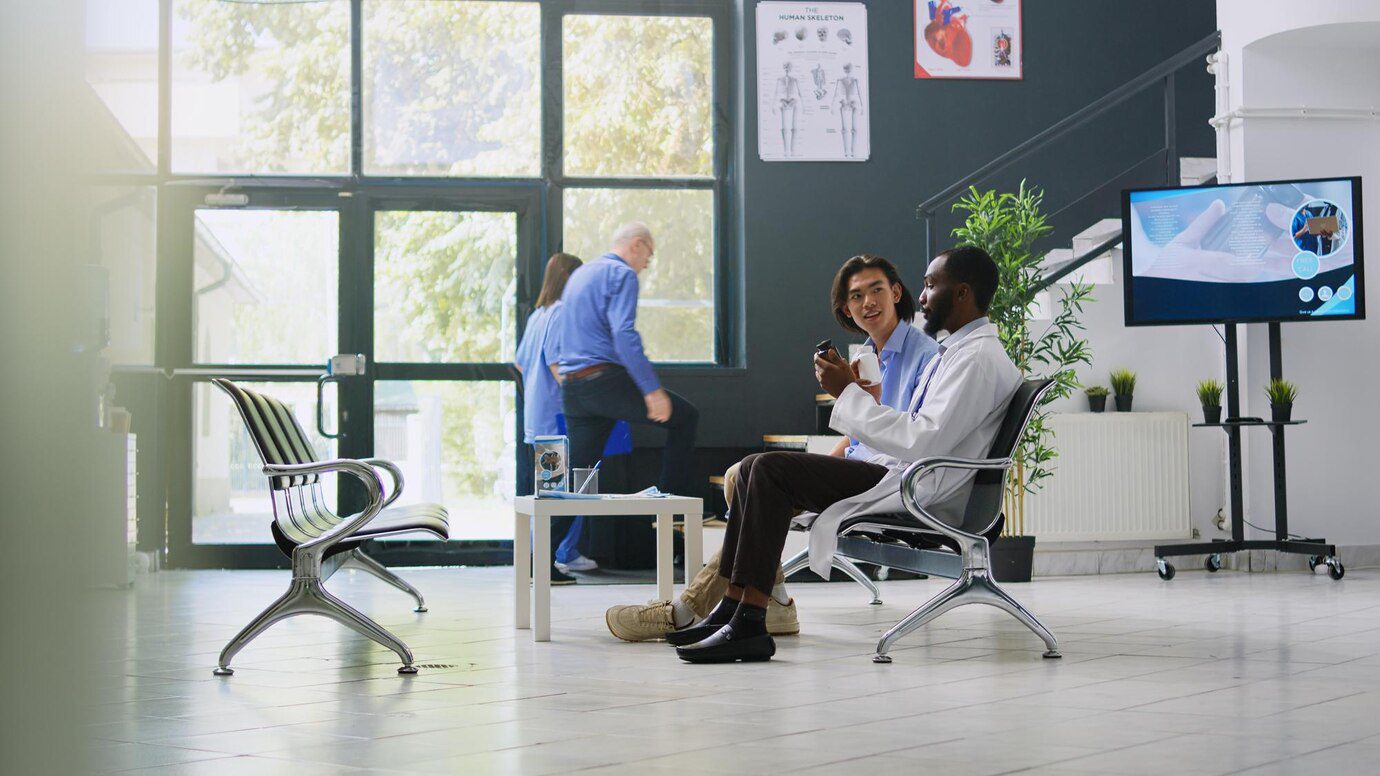 A group of people sitting in chairs and talking.