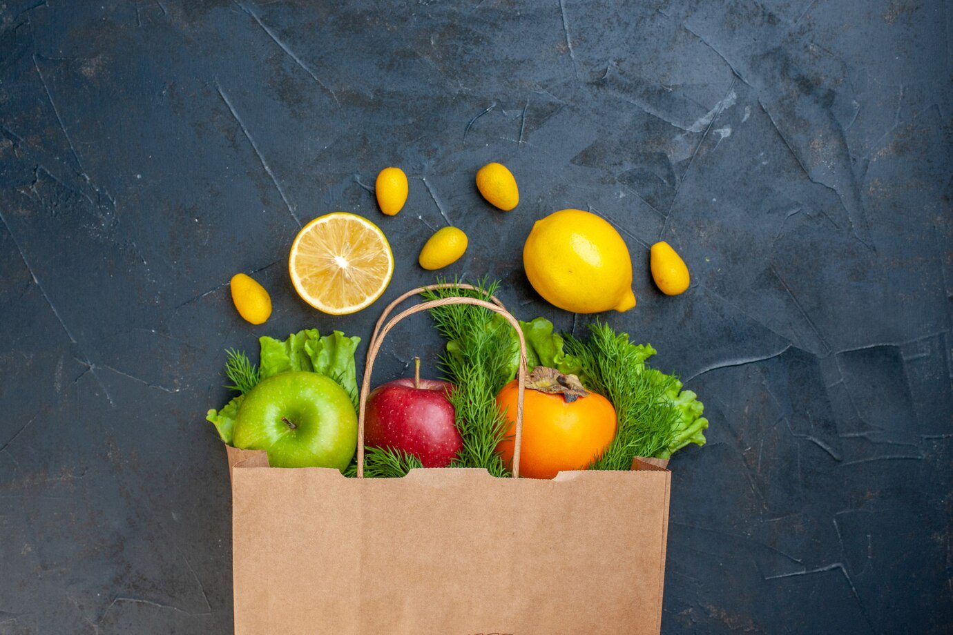 A bag of fruit with lemons and apples