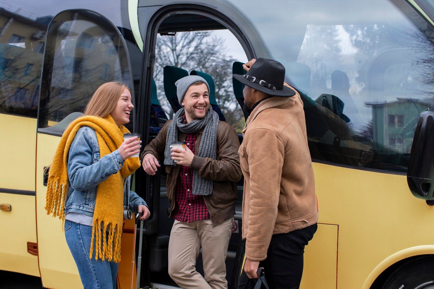 A group of people standing next to a bus.