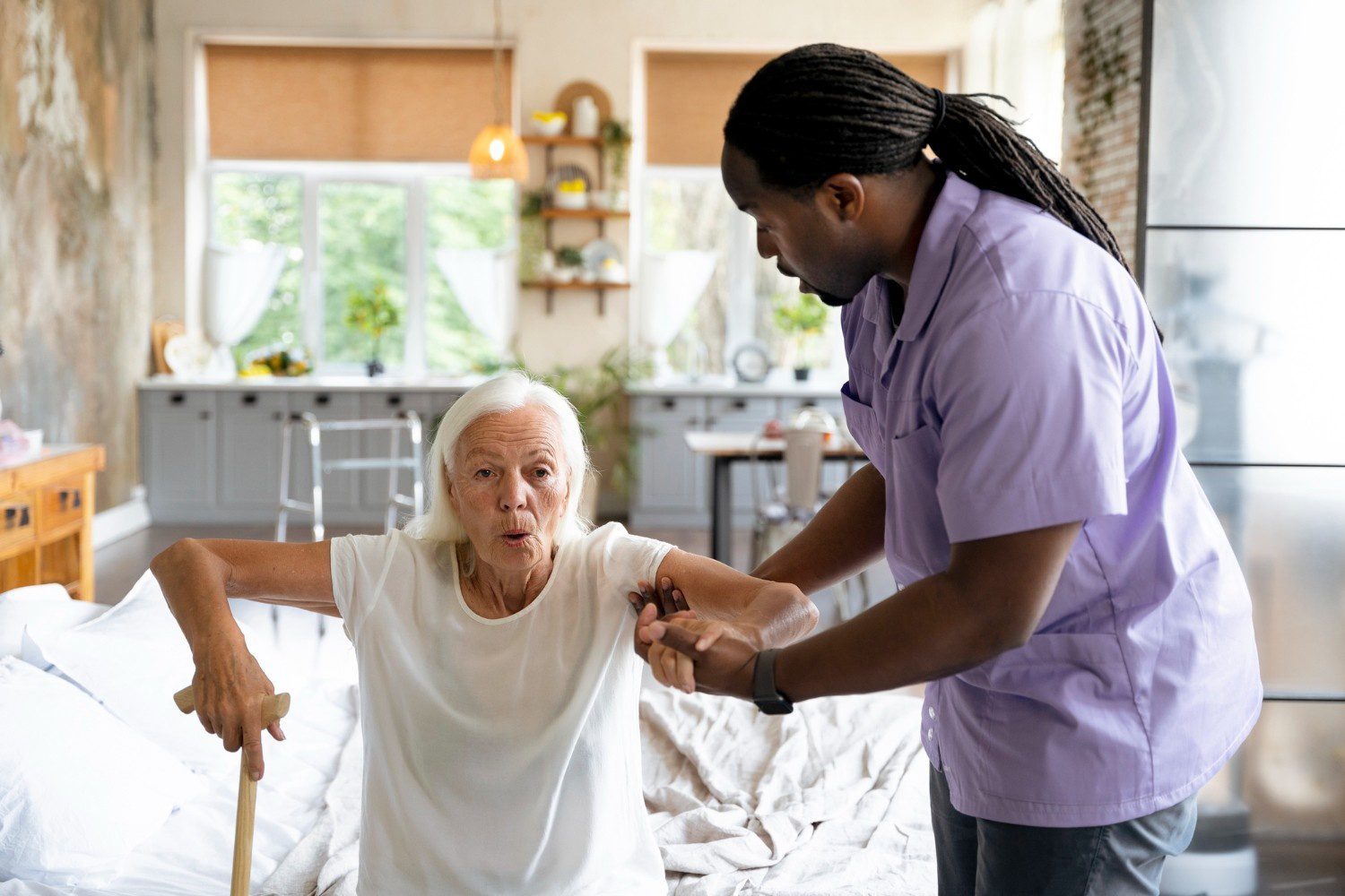 A man helping an elderly woman walk with a cane.