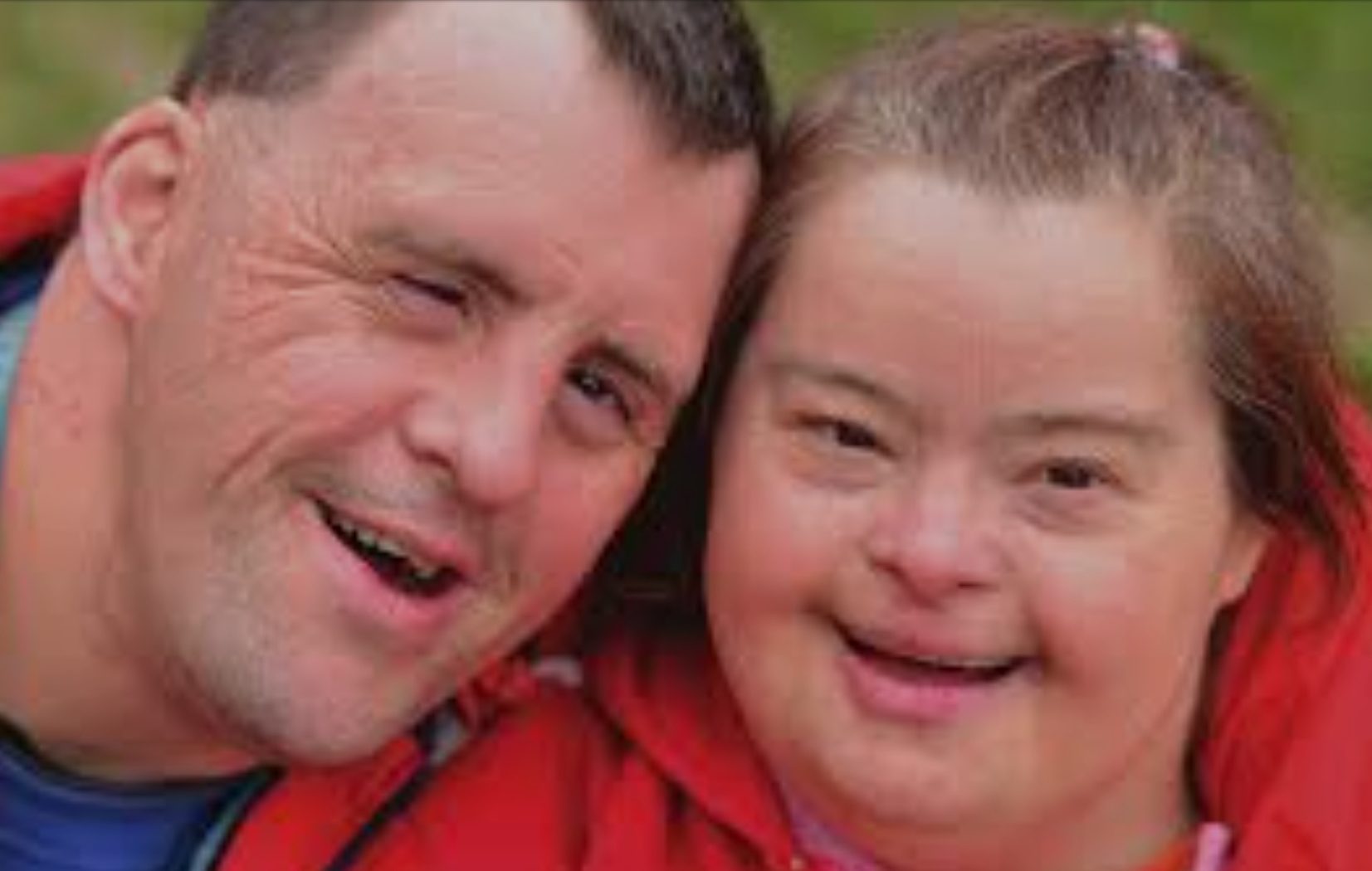 A man and woman smiling for the camera.