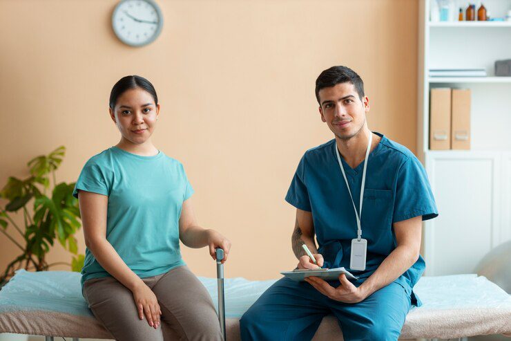 A man and woman sitting on the couch in front of a clock.